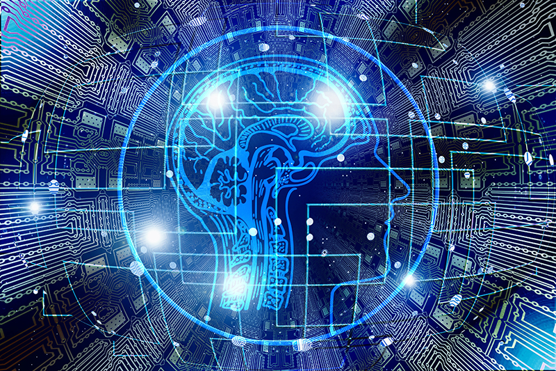 An illustration of a human brain overlaid by computer chips