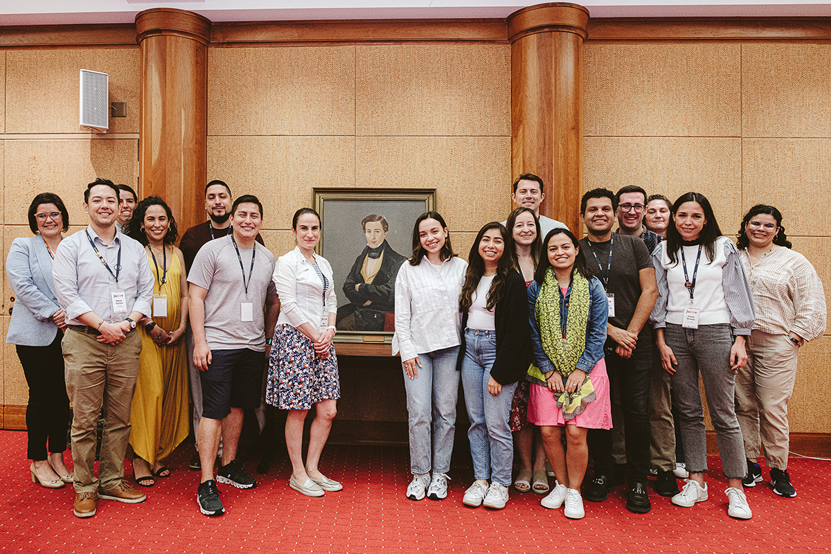 Members of UVA’s Latinx community pose in front of a portrait of Fernando Bolívar.