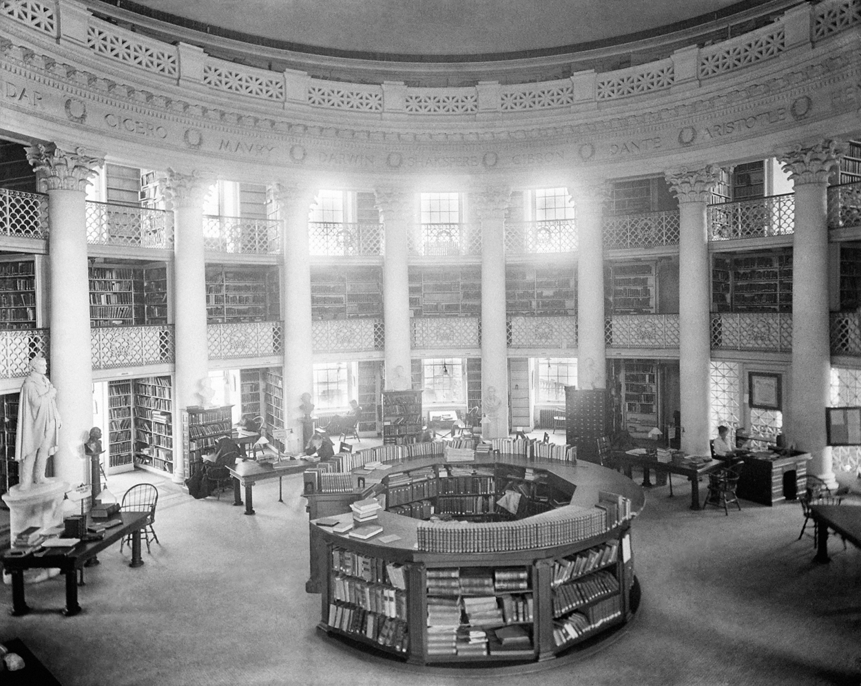 A tall circular room with books and studying spaces.