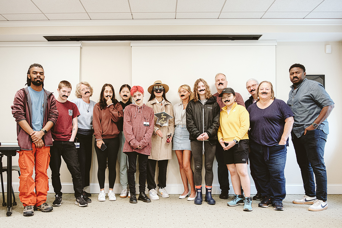 The Library's Digital Production group poses with fake Faulkereqsue mustaches.