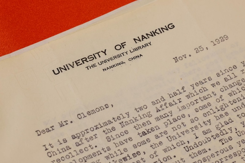 Close-up of a typewritten letter dated November 25, 1929, addressed "Dear Mr. Clemons," from the University of Nanking Library, located in Nanking, China. The content mentions significant developments over the past two and a half years at the university.