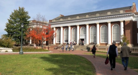 A columned building with grassy lawn out front