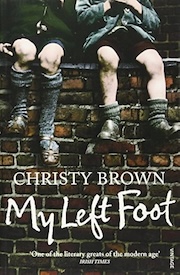 Book cover of "My Left Foot" by Christy Brown, featuring two individuals sitting on a wall with only their lower legs and feet visible, set against a brick background.